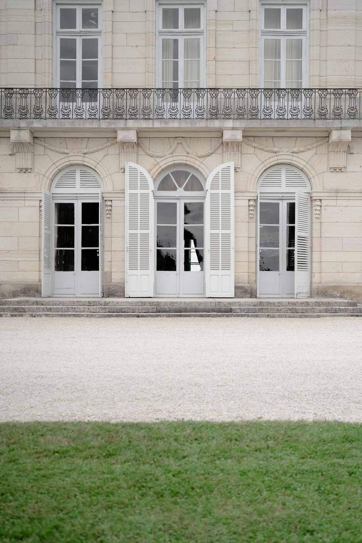 View of Chateau d'Arcelot garden through a vintage window