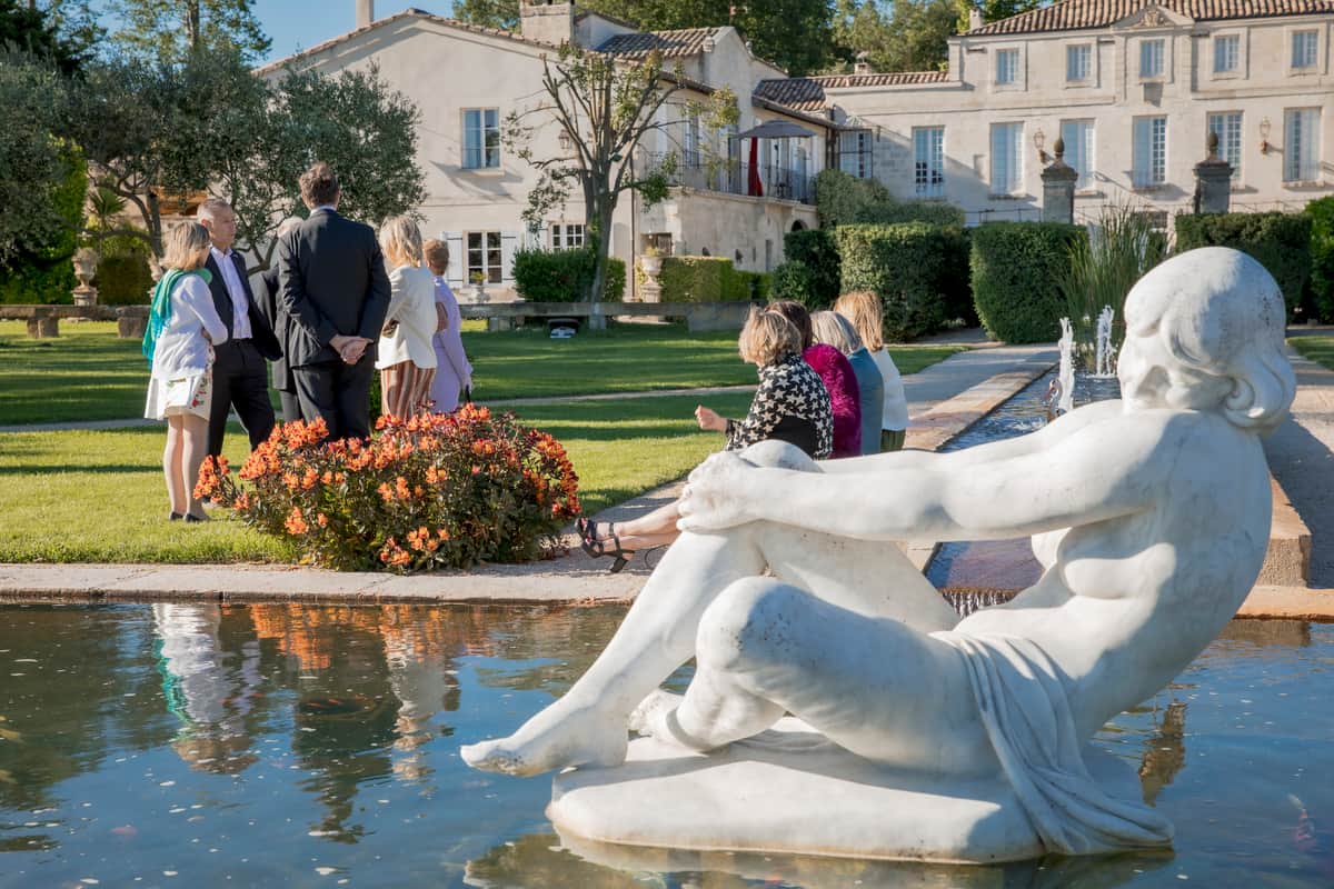 Guests gathered in the gardens beside the reflecting pool and fountain during cocktail hour