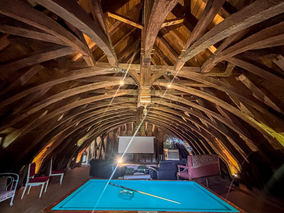 Vaulted reception hall at Chateau Eyparsac with exposed timber beams
