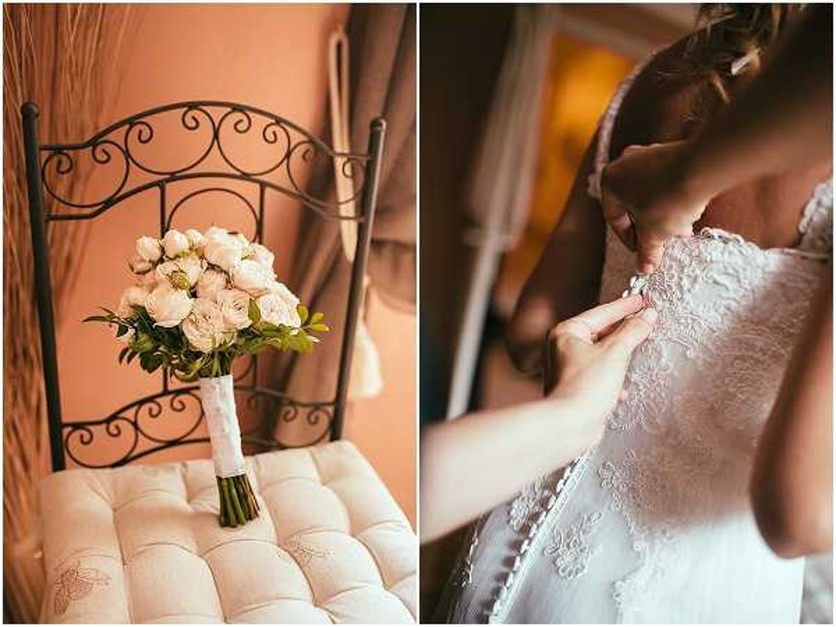 A two-image composite from the getting-ready portion of a wedding day. On the left, a bridal bouquet of blush and cream garden roses with green foliage, wrapped in a white ribbon handle, rests on the cushioned seat of a wrought-iron decorative chair against a warm terracotta-toned wall indoors. On the right, a close-up detail shot shows hands fastening the back buttons of a white lace wedding gown on a bride with a braided updo hairstyle, captured in a warmly lit interior room. Both images share a warm, golden indoor lighting tone and a classic, romantic styling direction.