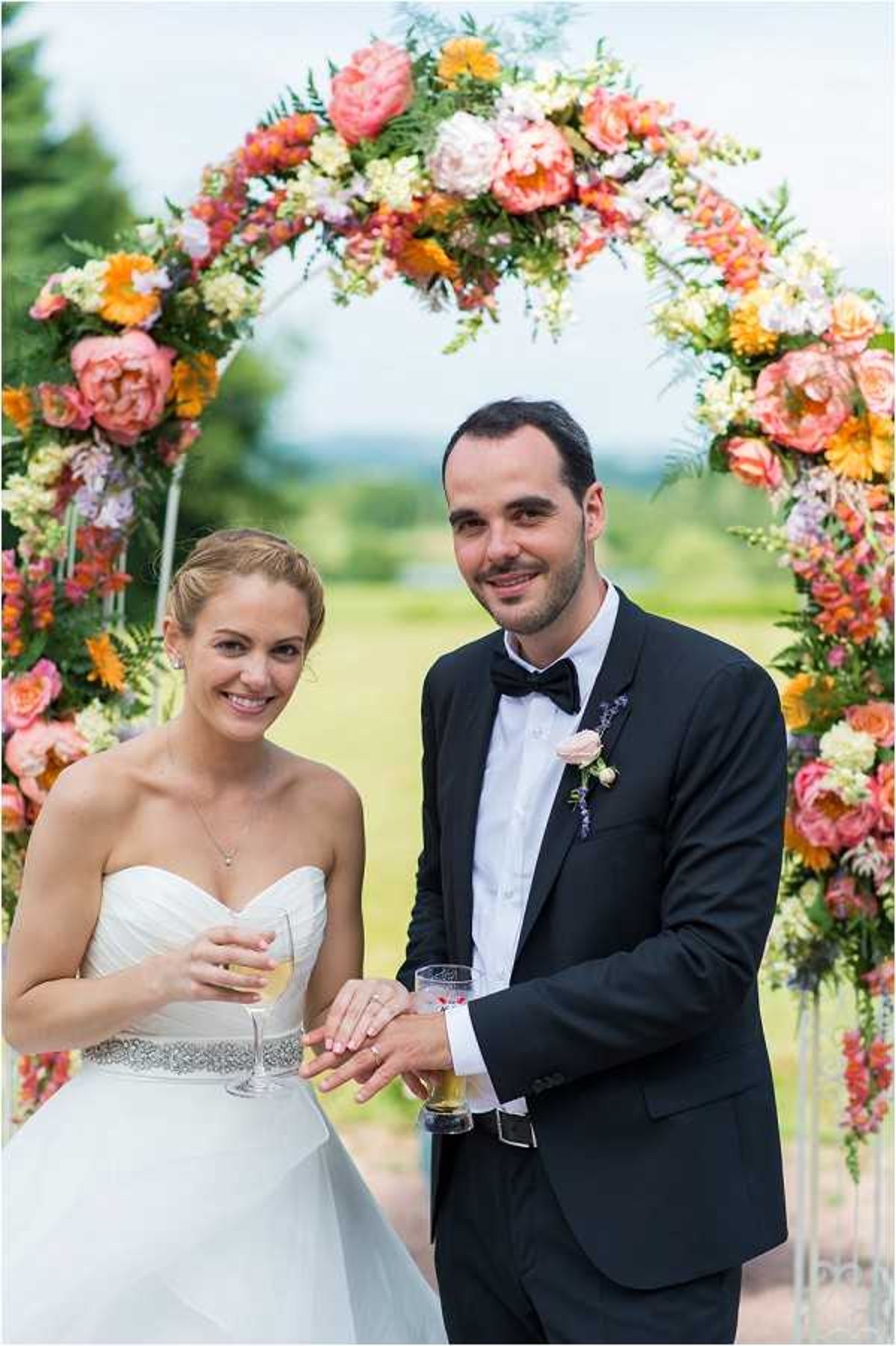 bright orange wedding flower arch