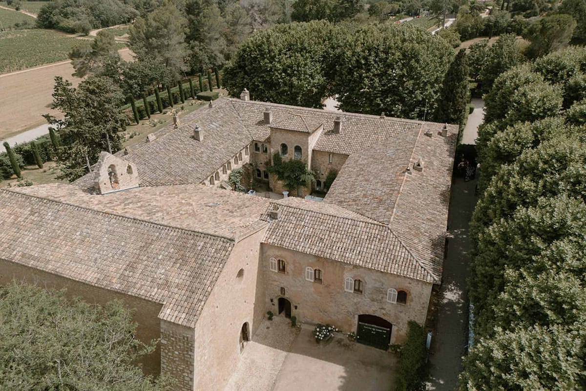 Aerial drone view of Château Sainte-Roseline estate with vineyards and cypresses