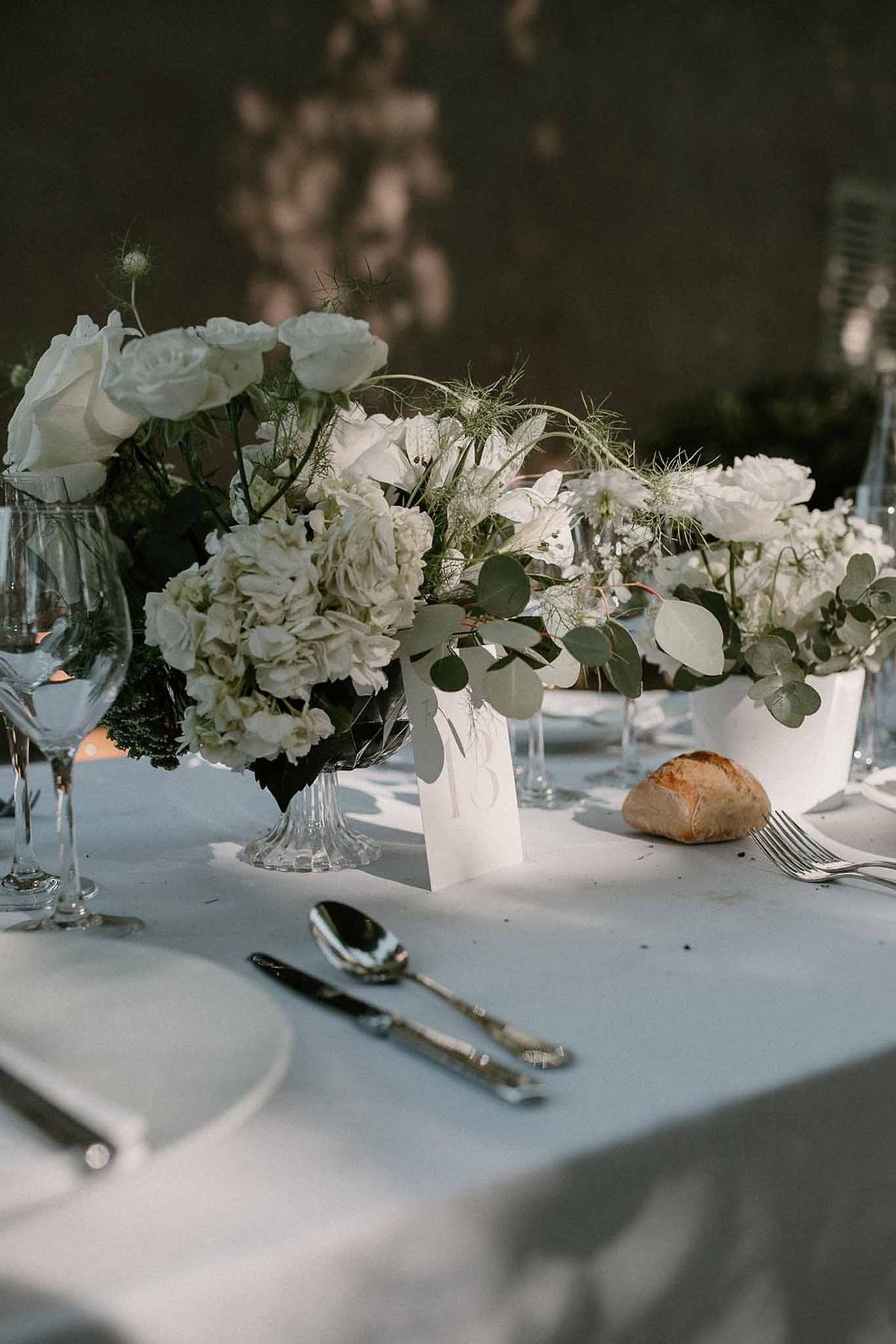 White rose and hydrangea centrepiece with eucalyptus at Château Sainte-Roseline