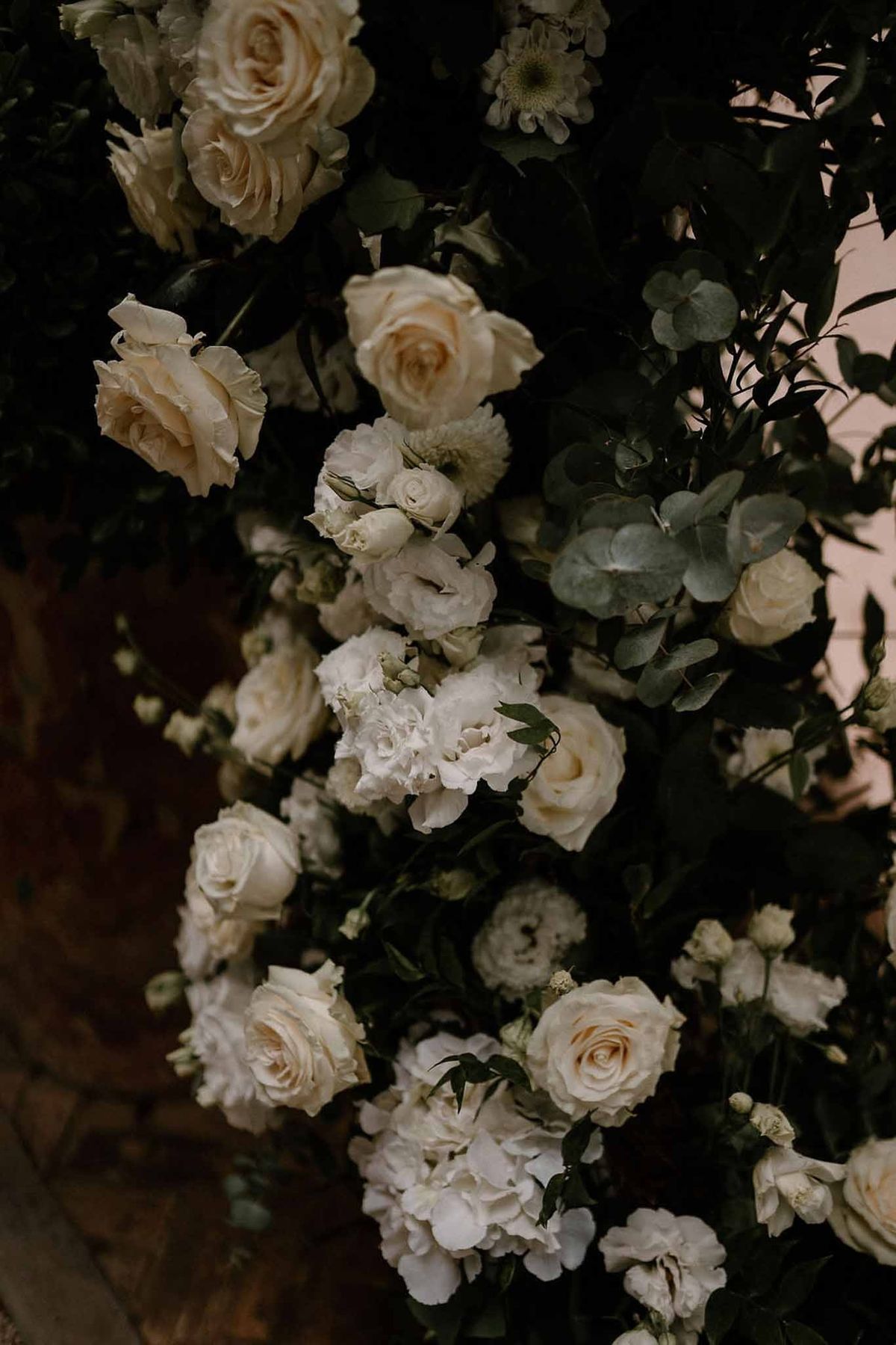 Close-up of white roses and eucalyptus on ceremony arch at Château Sainte-Roseline