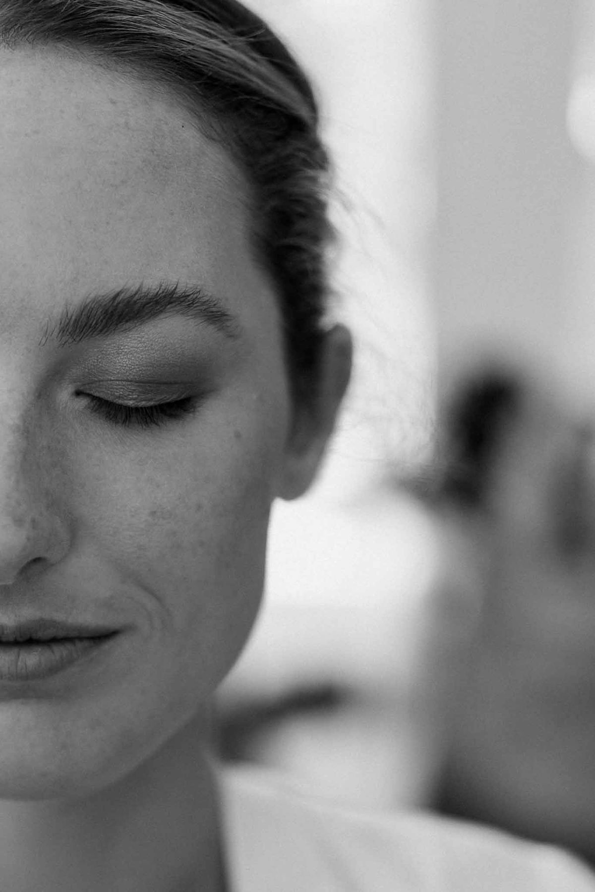 Bride's face close-up with natural makeup in black and white at Château Sainte-Roseline