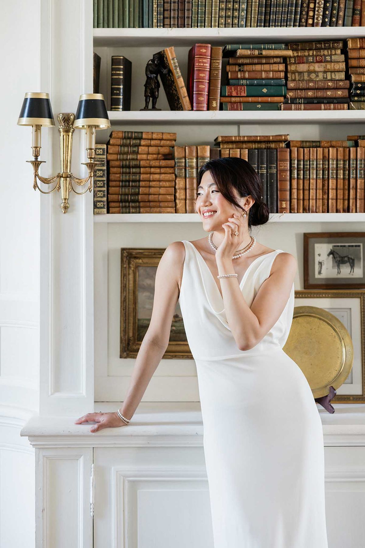 Bride posing in a library at a French chateau