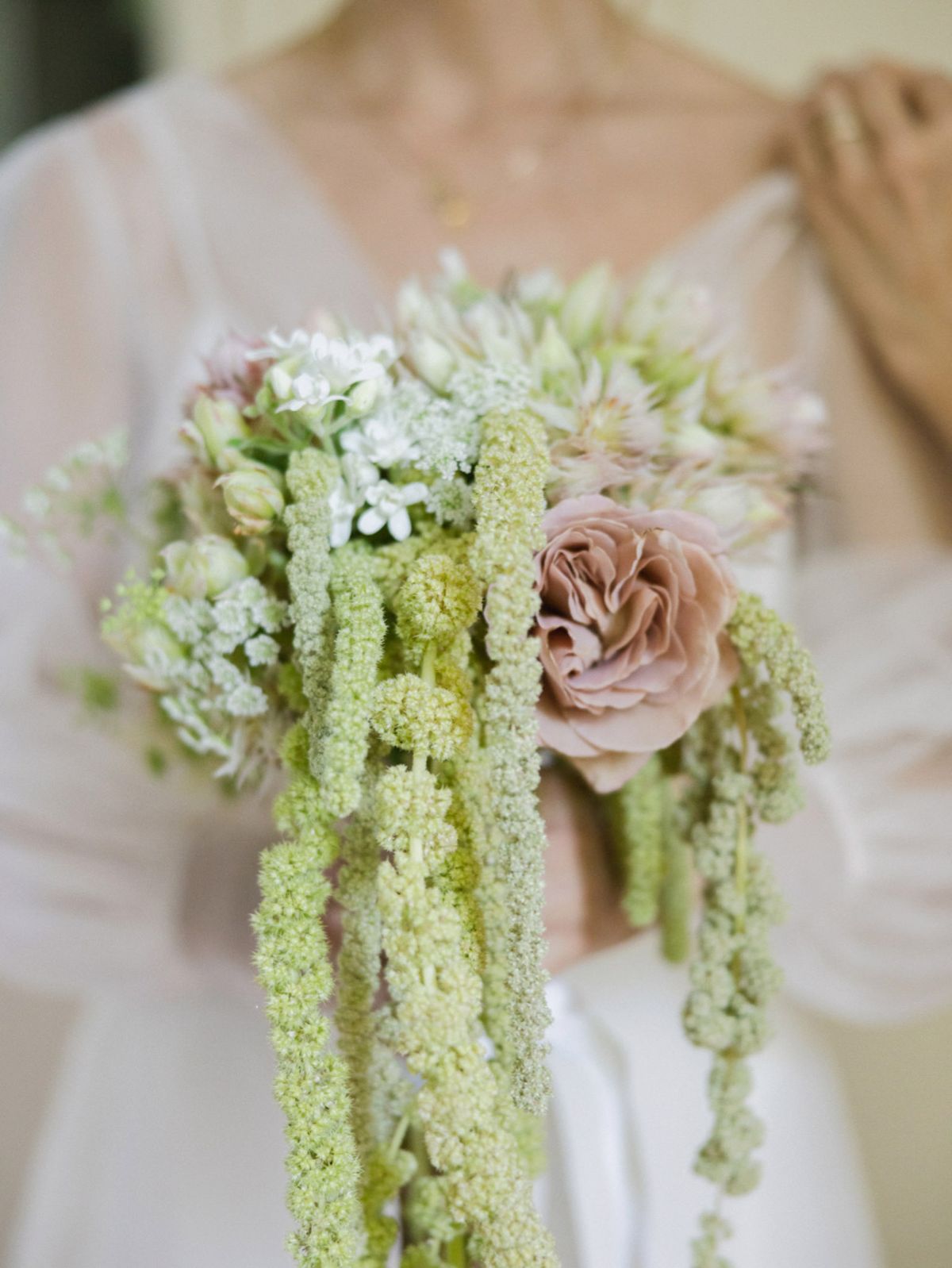 Bridal bouquet with cascading chartreuse Queen Anne's lace, white baby's breath, and single dusty rose garden rose