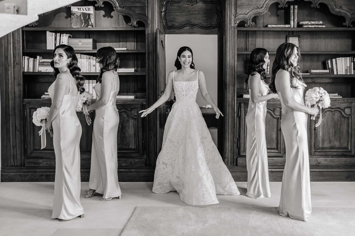 Black and white bridal party portrait with bride and four bridesmaids in ivory satin dresses