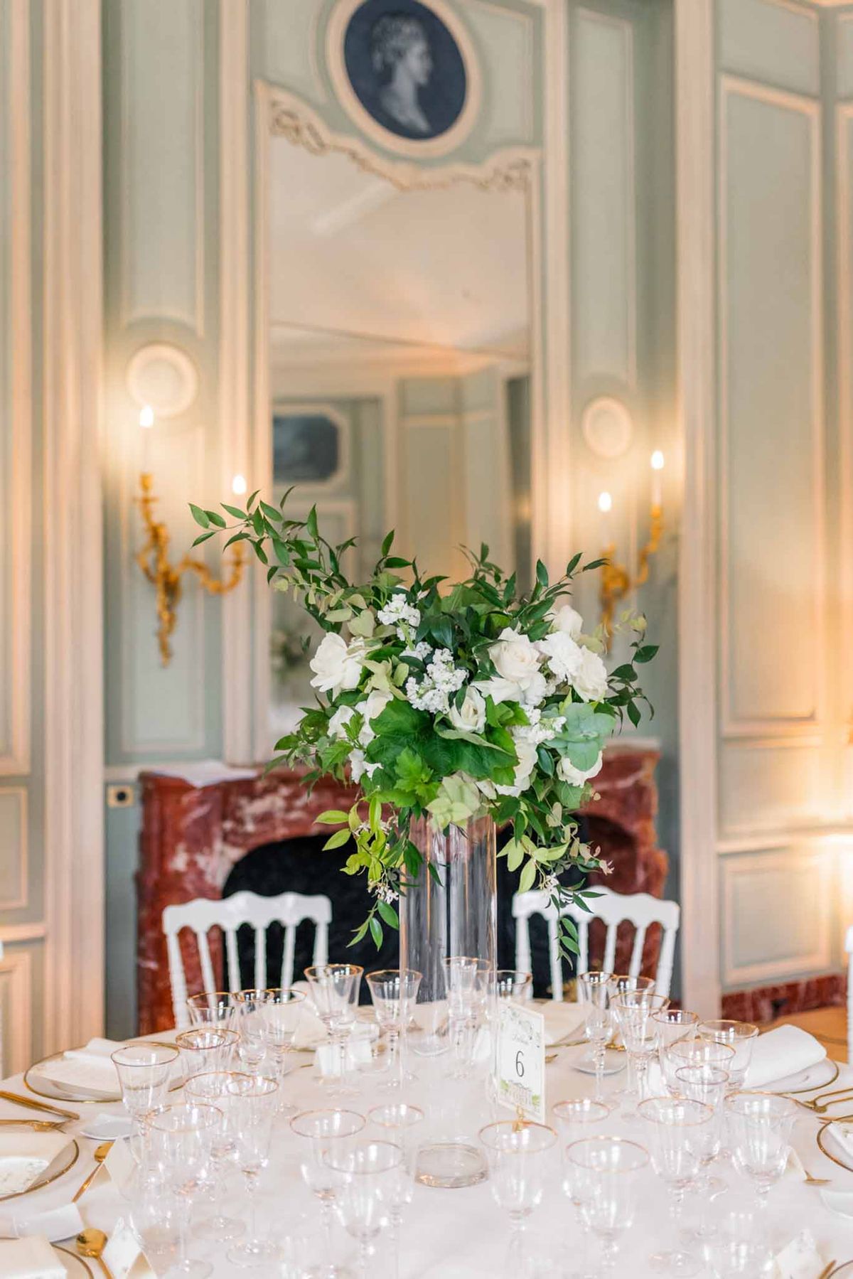 Reception table detail with white floral centrepiece in classical French interior