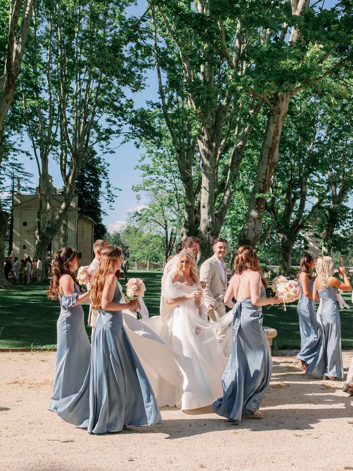 Bride and groom with their bridal party in a garden setting