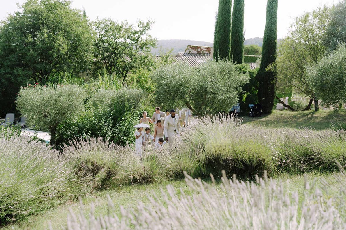 Wedding ceremony in lavender field at hillside Mediterranean estate with stone villa