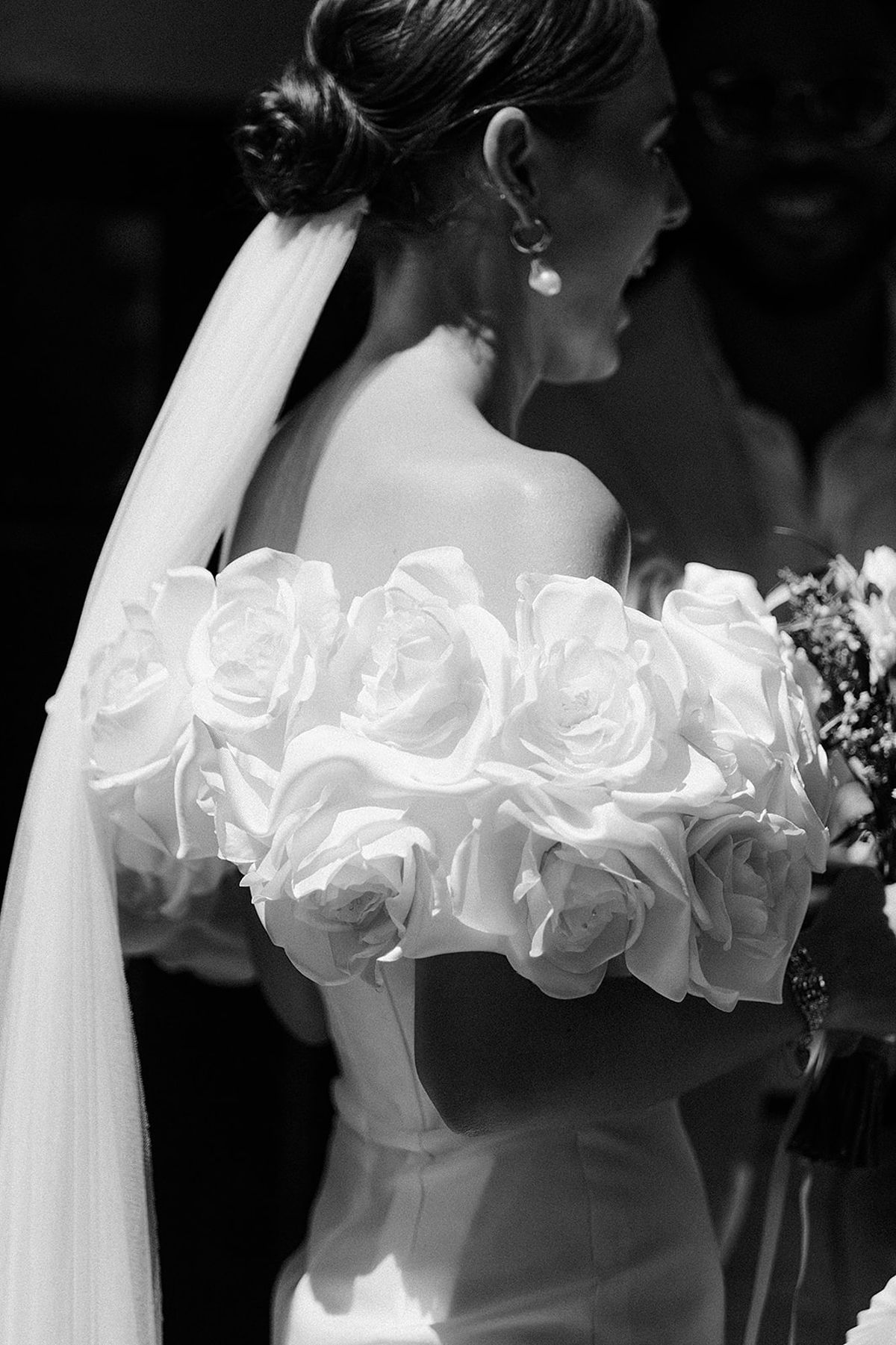 Black and white bride portrait with bouquet and veil at wedding venue