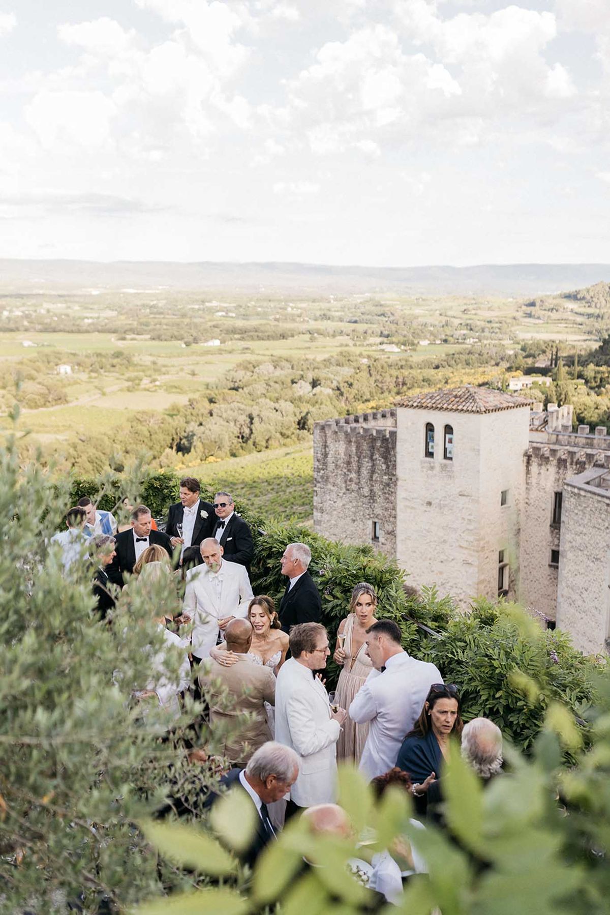 Wedding cocktail hour on medieval fortress terrace with Tuscan countryside views