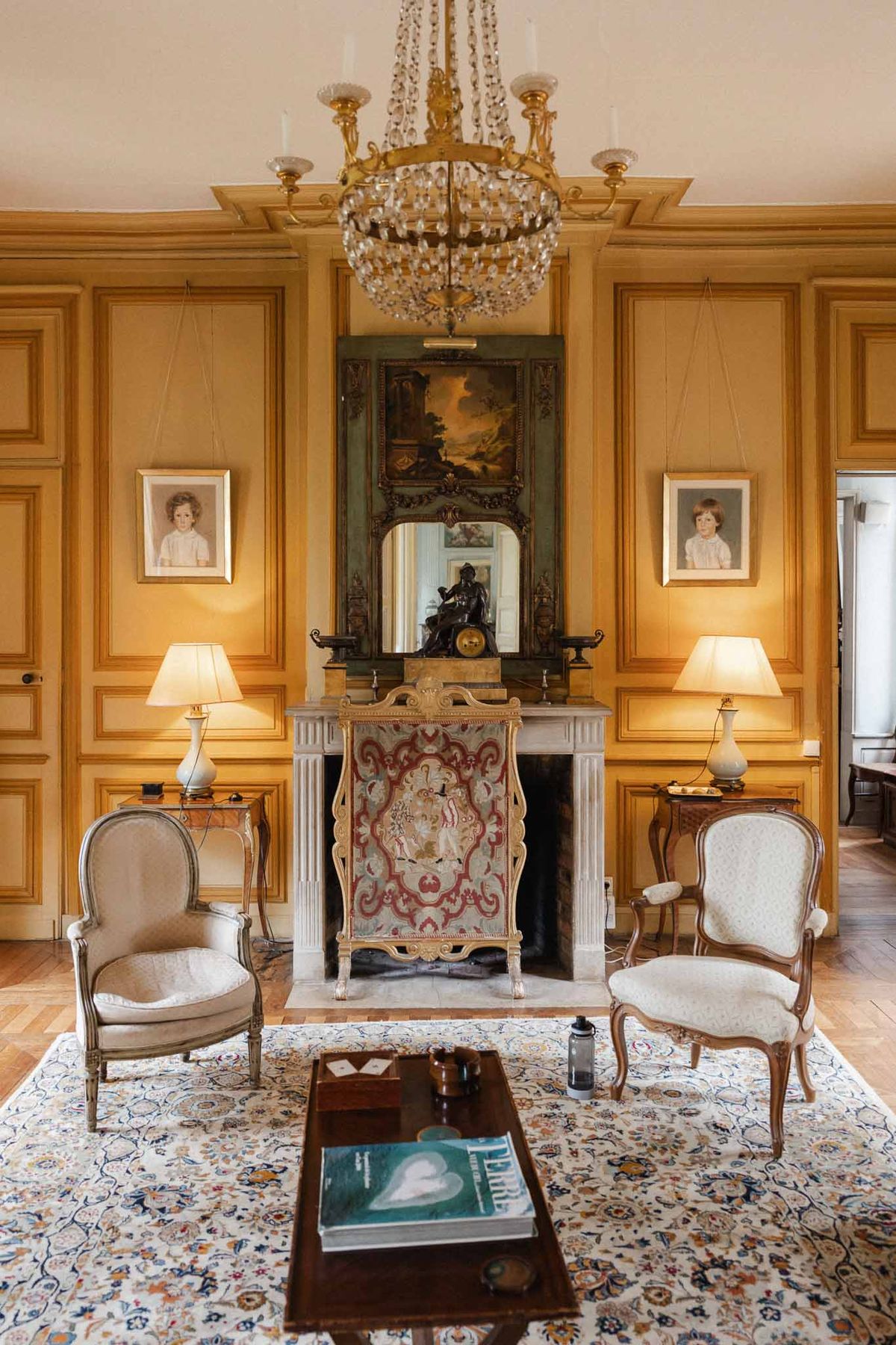 Classical French château interior room with golden paneled walls and period furnishings for weddings