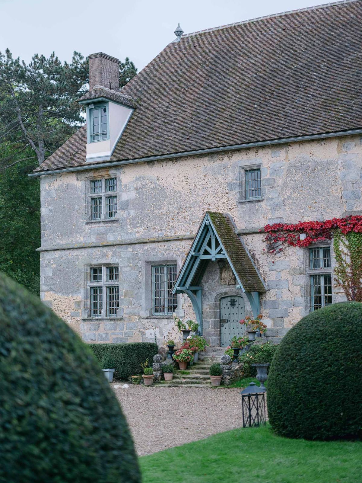 Historic stone manor house wedding venue with ivy-covered facade and landscaped courtyard