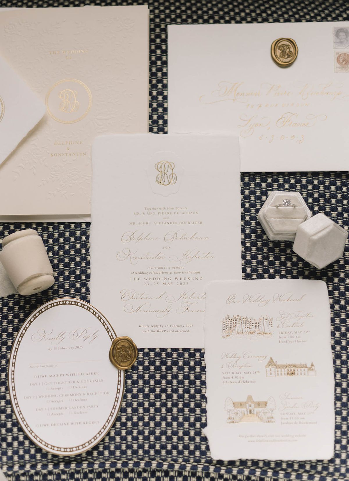 Wedding invitation suite with gold foil monogram and navy geometric patterns arranged as flat lay