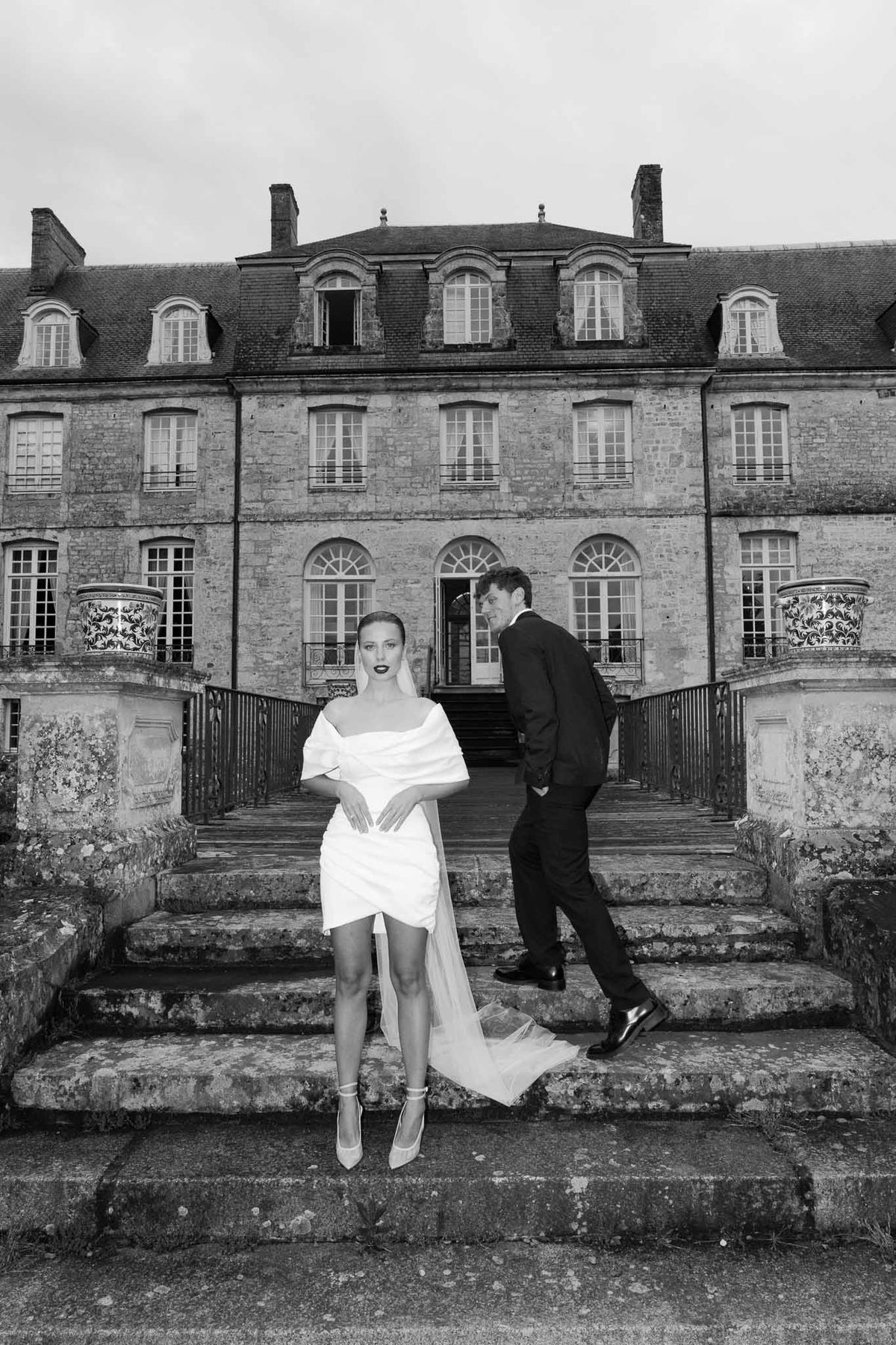 Bride and groom portrait on stone staircase at historic mansion venue
