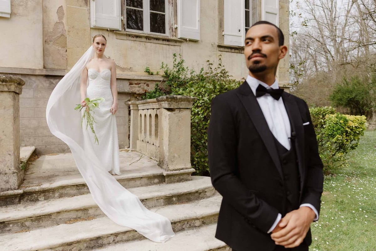 Bride and groom portrait session in historic stone château courtyard with ivy-covered walls