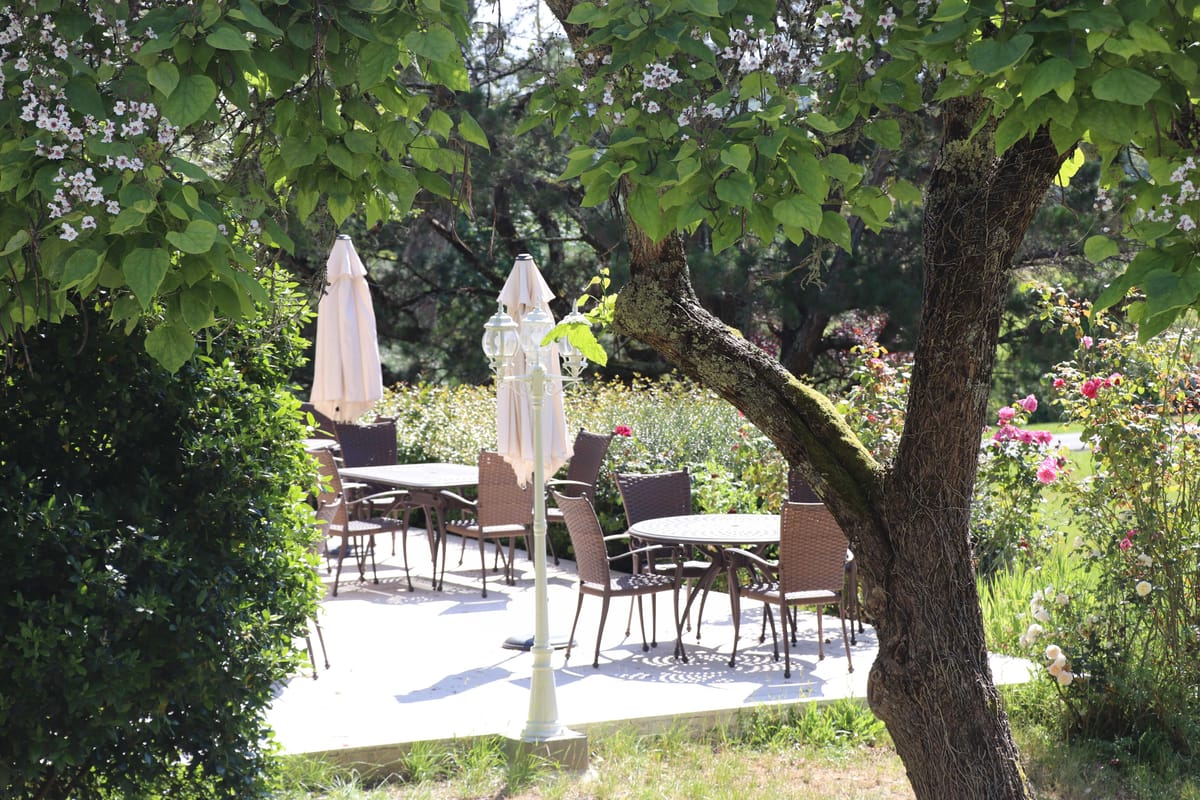 Wedding reception table setting in a garden with white roses