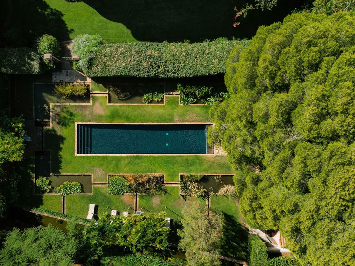 Aerial view of outdoor pool surrounded by Mediterranean gardens at Domaine Rocabella, French Riviera