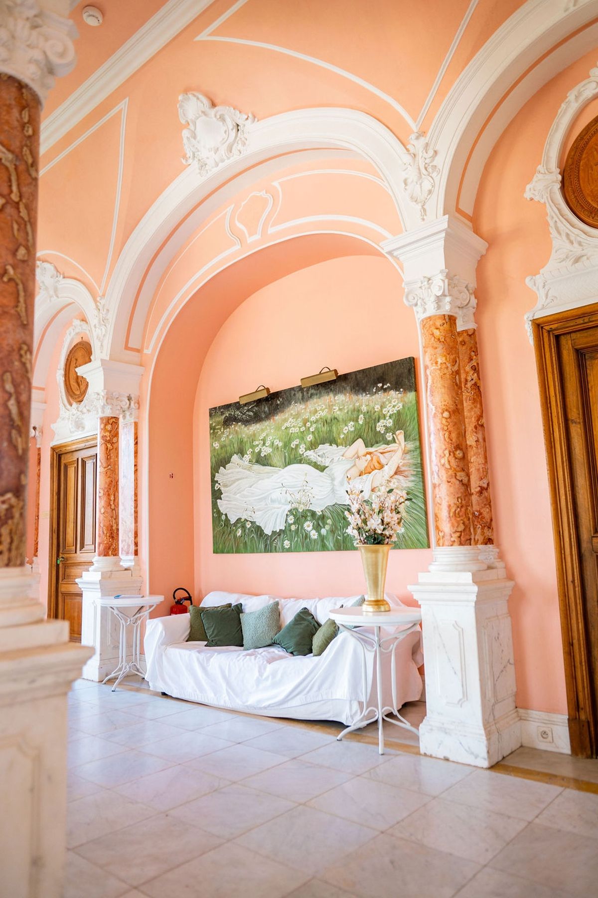 Pink salon with marble columns and oil painting at Domaine Rocabella, French Riviera