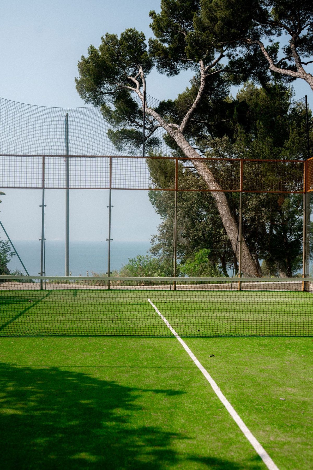 Private tennis court with sea view among pine trees at Domaine Rocabella, French Riviera