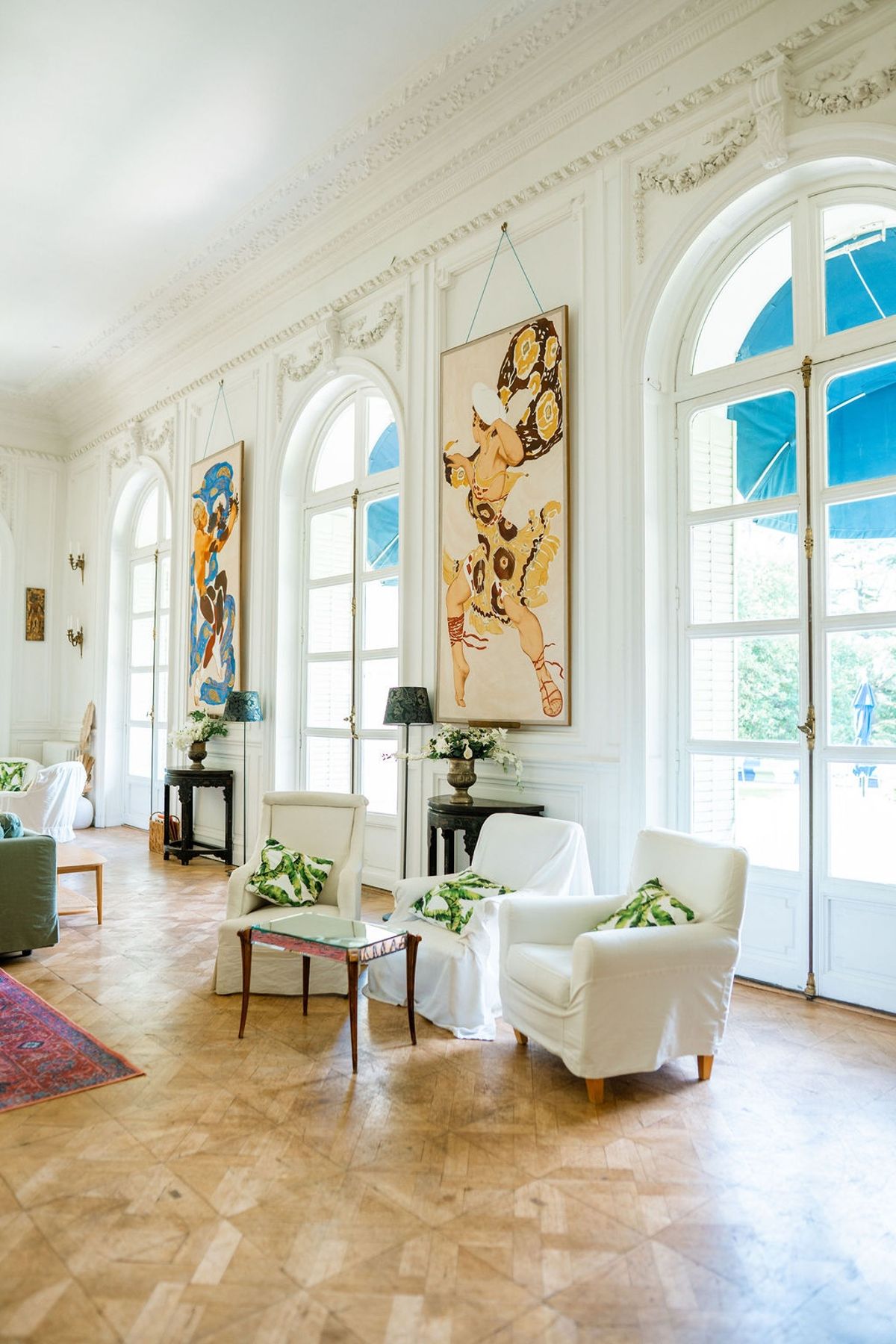 Elegant white reception room with arched French doors at Domaine Rocabella, French Riviera