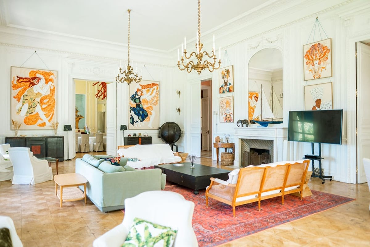 White salon with chandelier and contemporary art at Domaine Rocabella, French Riviera