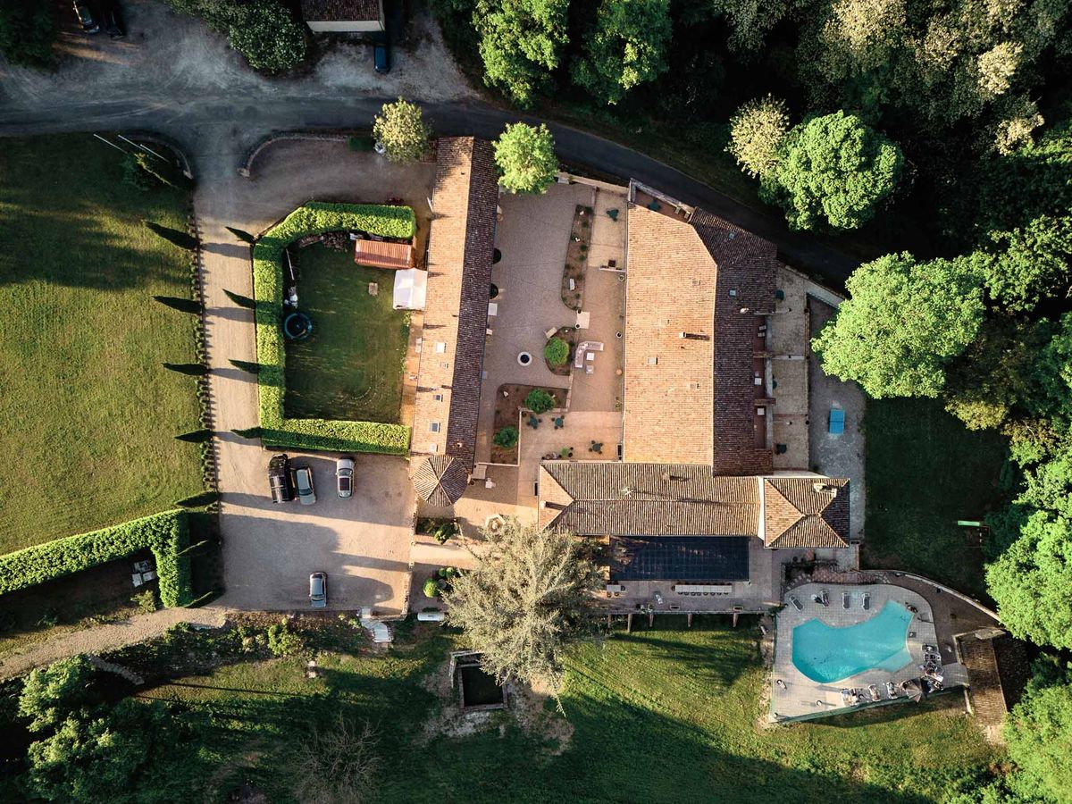 Overhead aerial of Chateau de Sanse buildings and pool terrace Bordeaux
