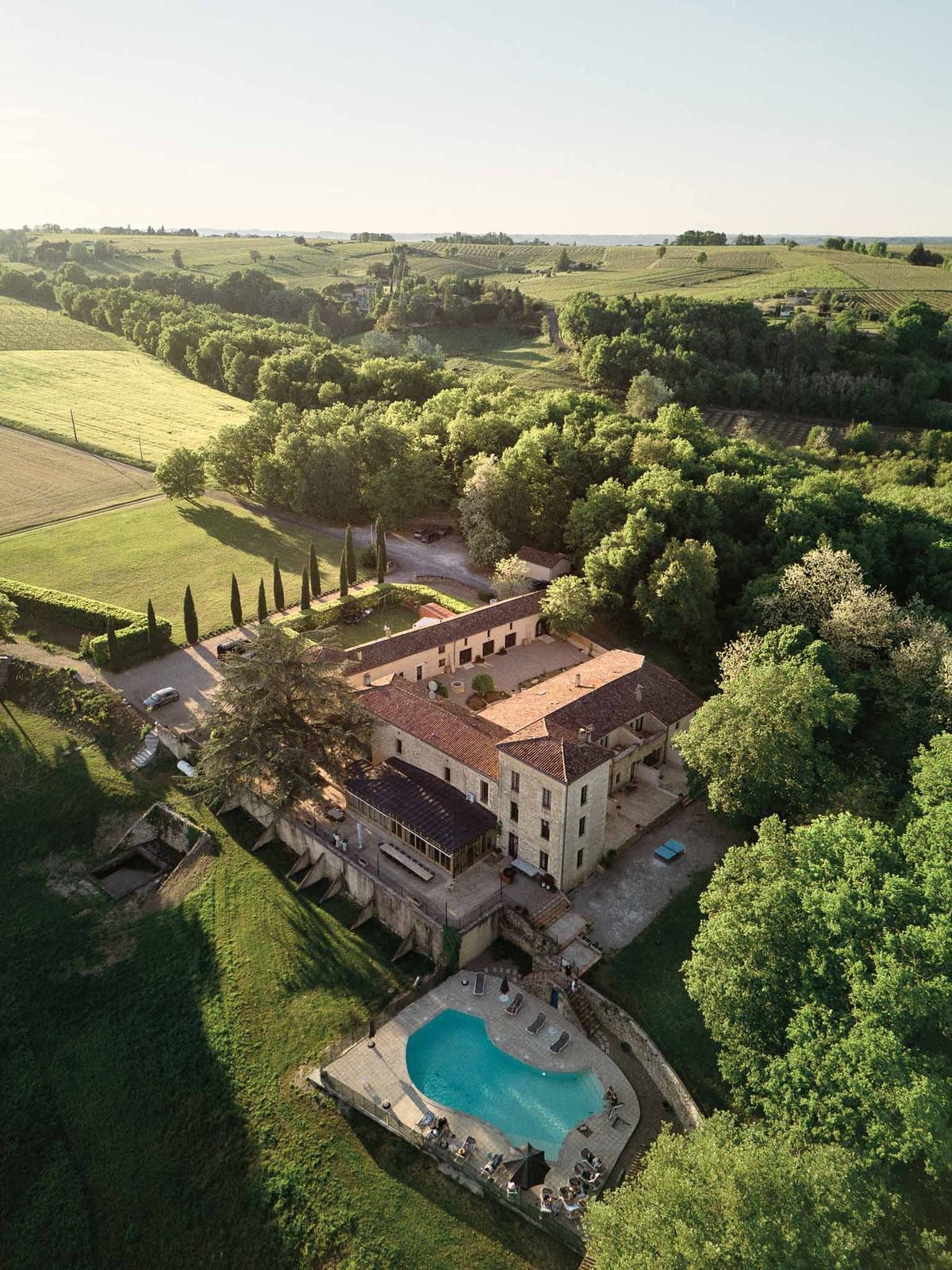 Golden hour aerial of Chateau de Sanse with sunset light Bordeaux