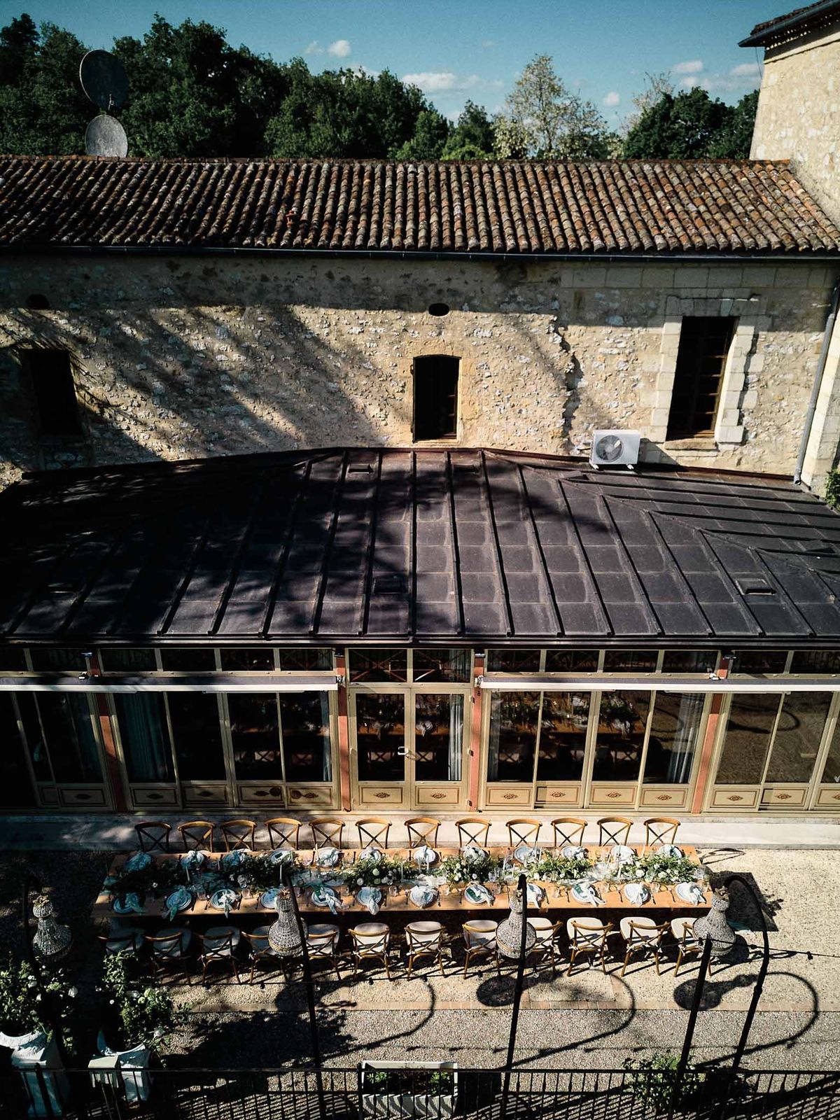 Aerial of glass conservatory with reception table at Chateau de Sanse Bordeaux