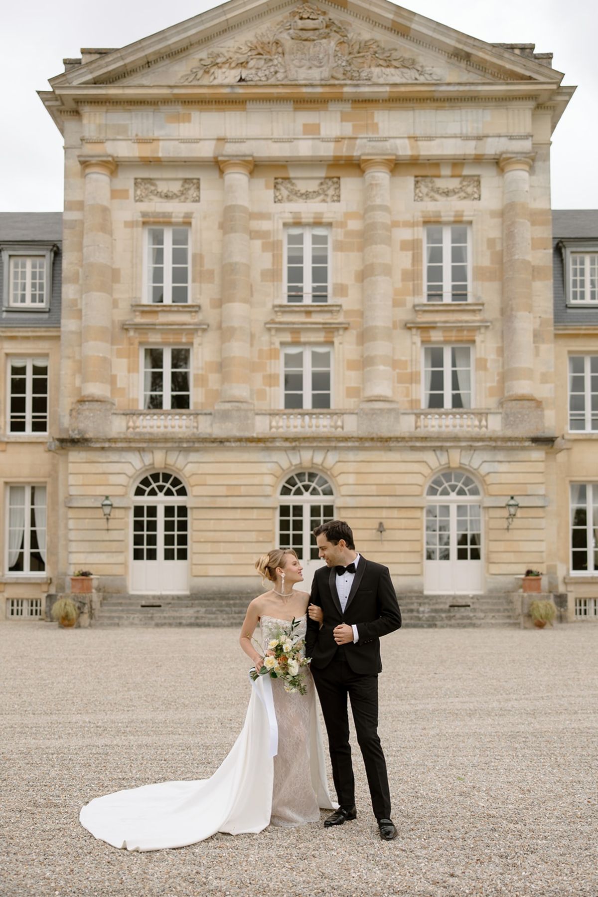 Couple in front of Chateau de Courtomer facade, Normandy