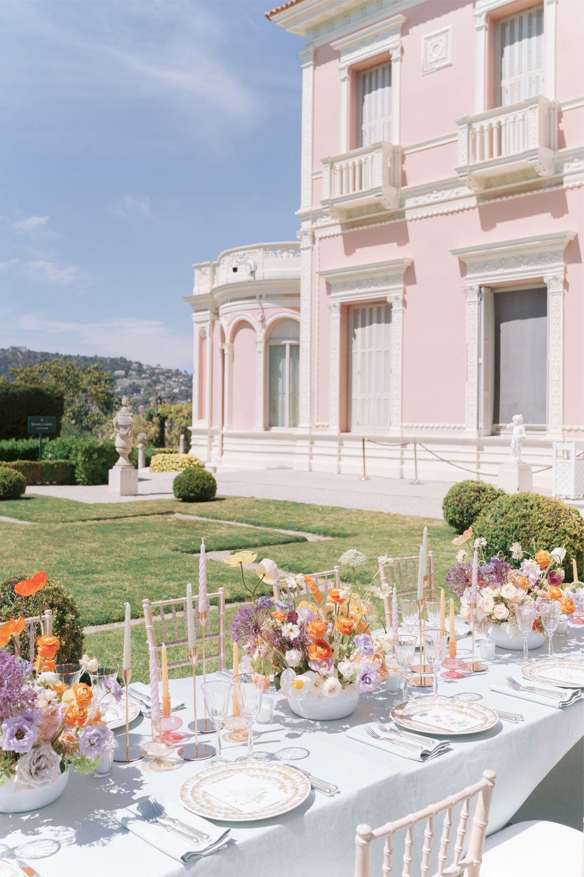 Wedding reception table setting in a garden with white roses
