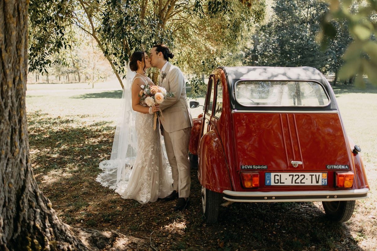 Bride and groom kissing in a garden