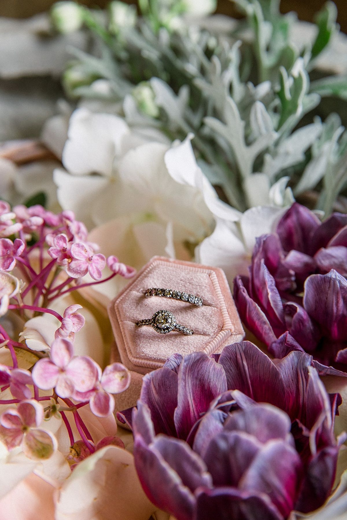 Diamond wedding rings in blush ring box with florals at Chateau Challain, Loire Valley