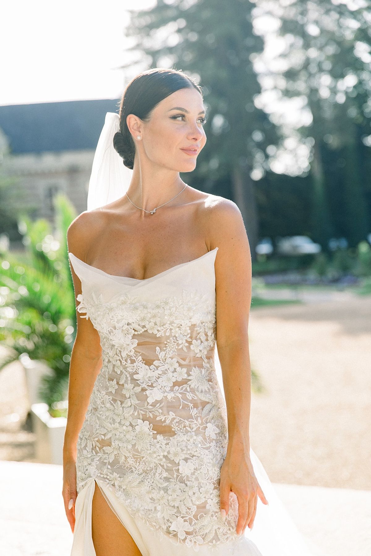 Bride in strapless floral lace gown at Chateau Challain, Loire Valley