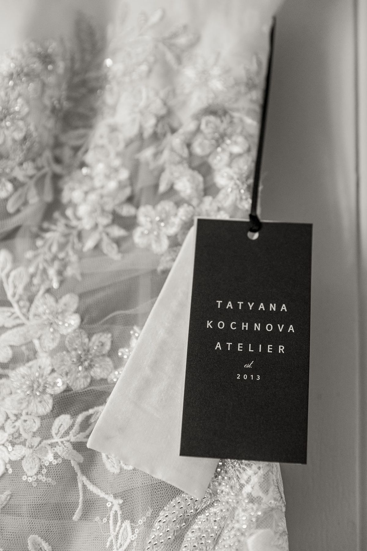 Close-up of bridal gown lace and designer tag at Chateau Challain, Loire Valley