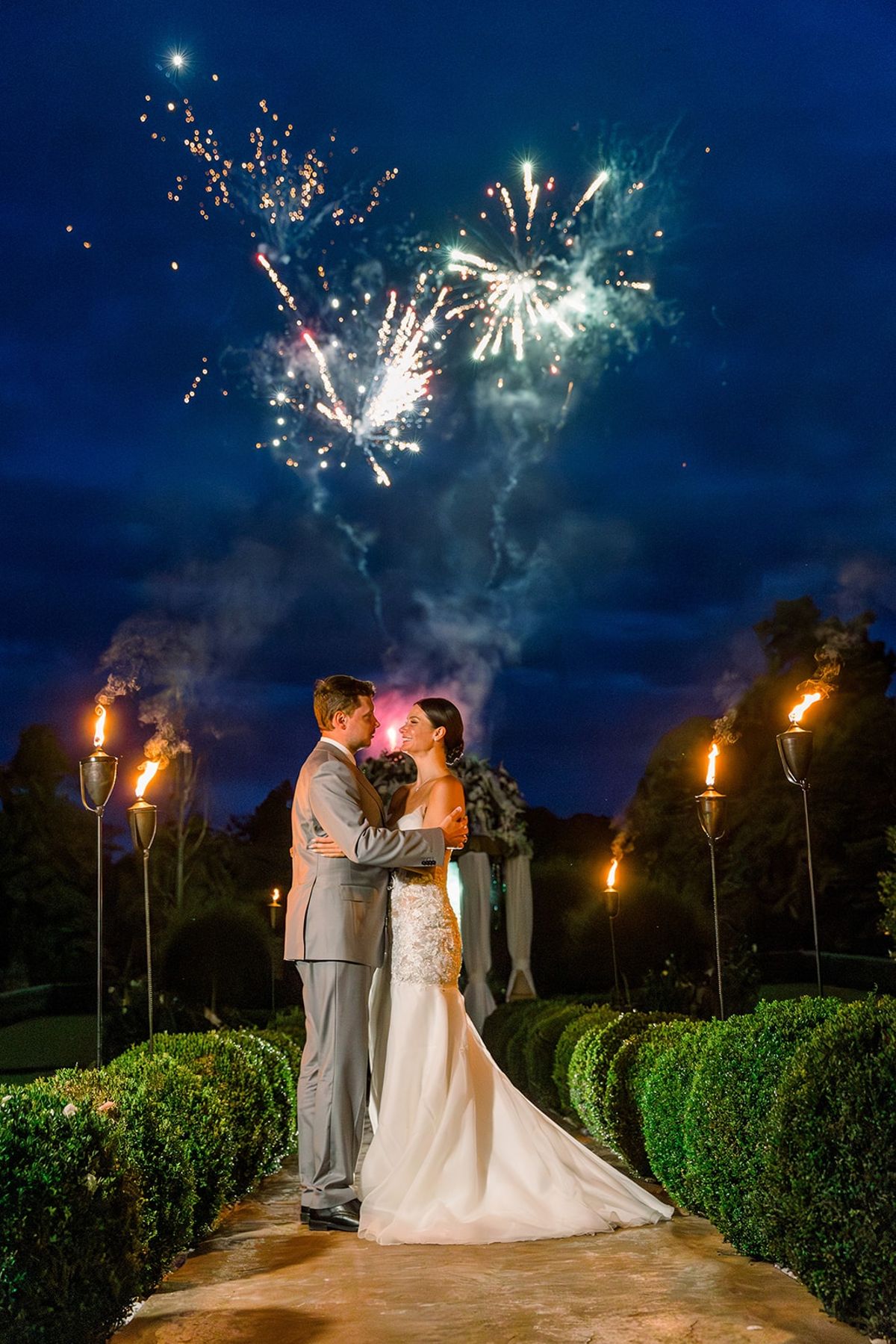Couple under fireworks in garden at night at Chateau Challain, Loire Valley
