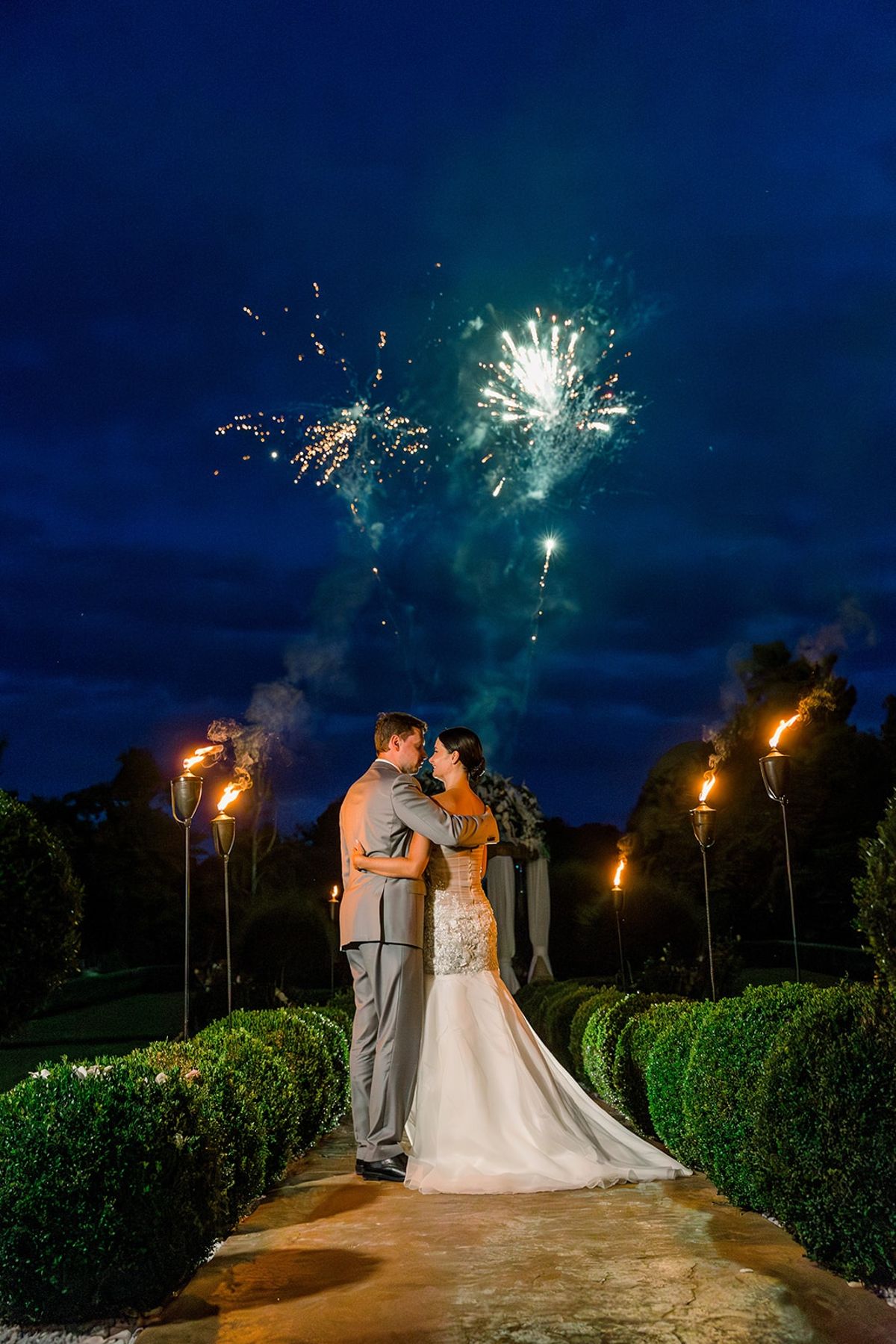 Bride and groom embracing under fireworks at Chateau Challain, Loire Valley