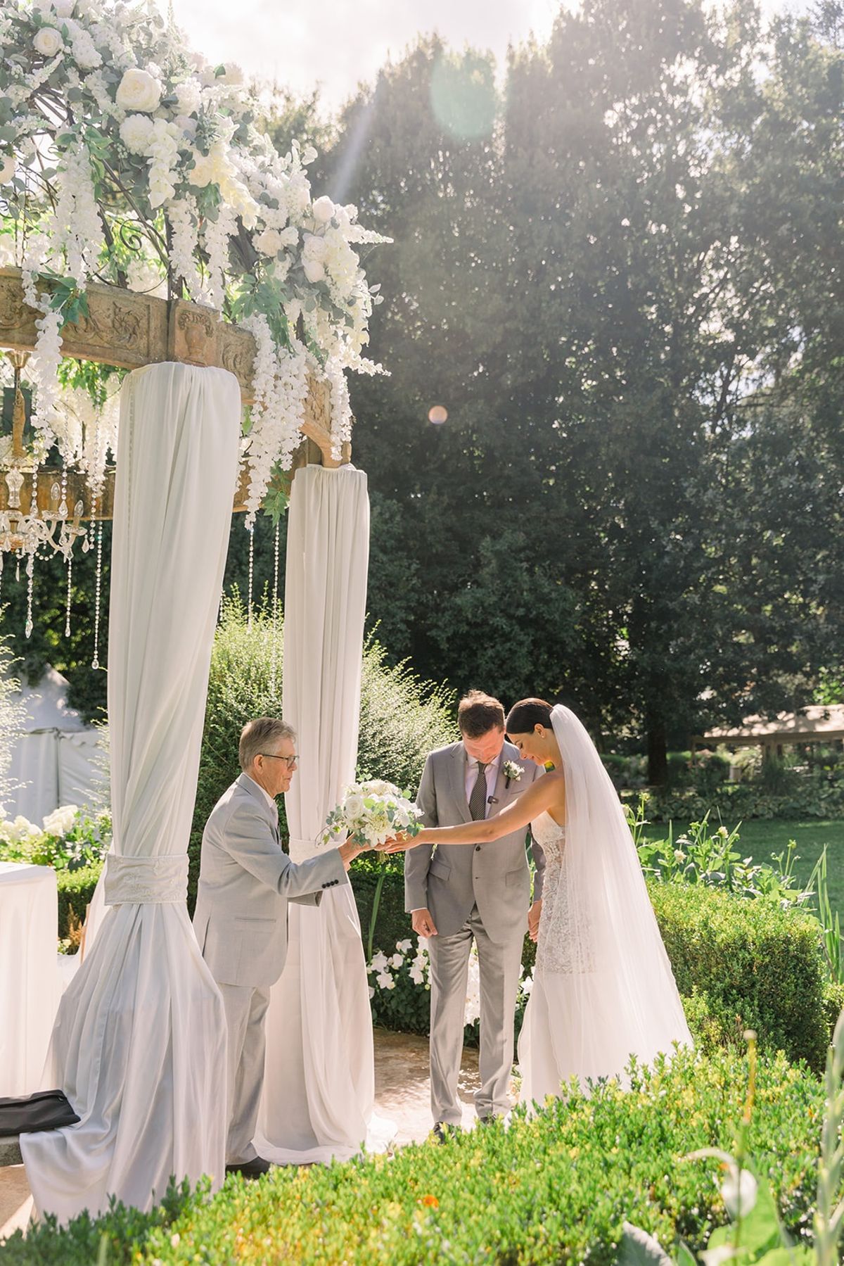 Couple receiving bouquet during ceremony at Chateau Challain, Loire Valley