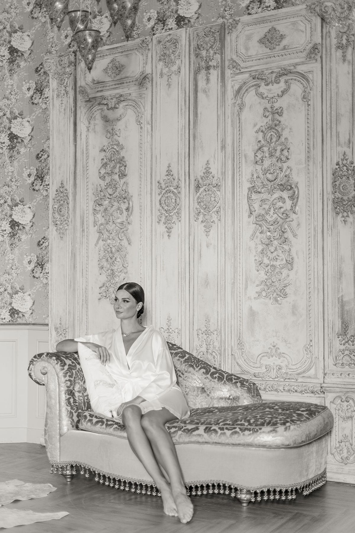 Bride reclining on chaise in vintage dressing room at Chateau Challain, Loire Valley