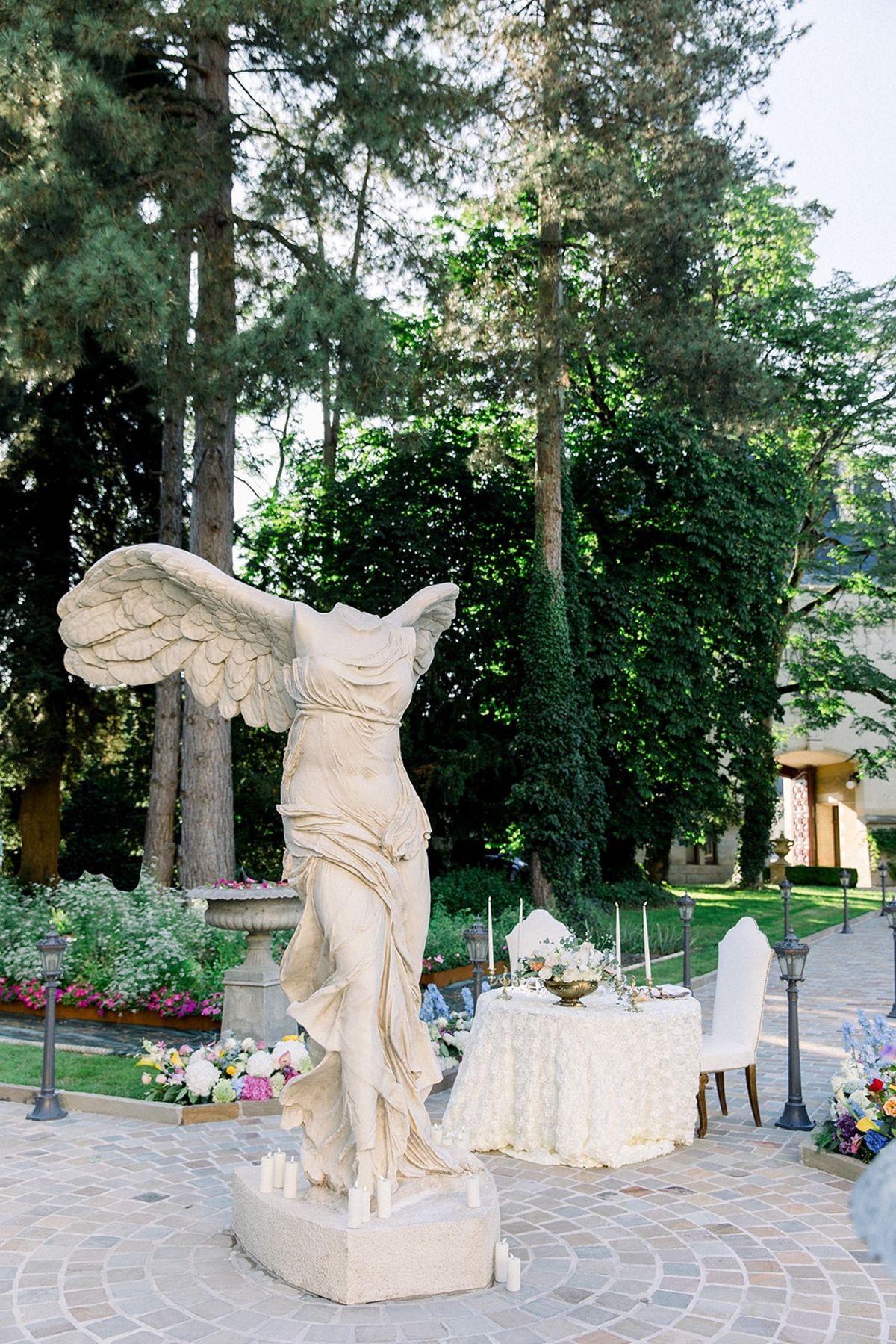 Sweetheart tablescape beside winged statue at Chateau Challain, Loire Valley