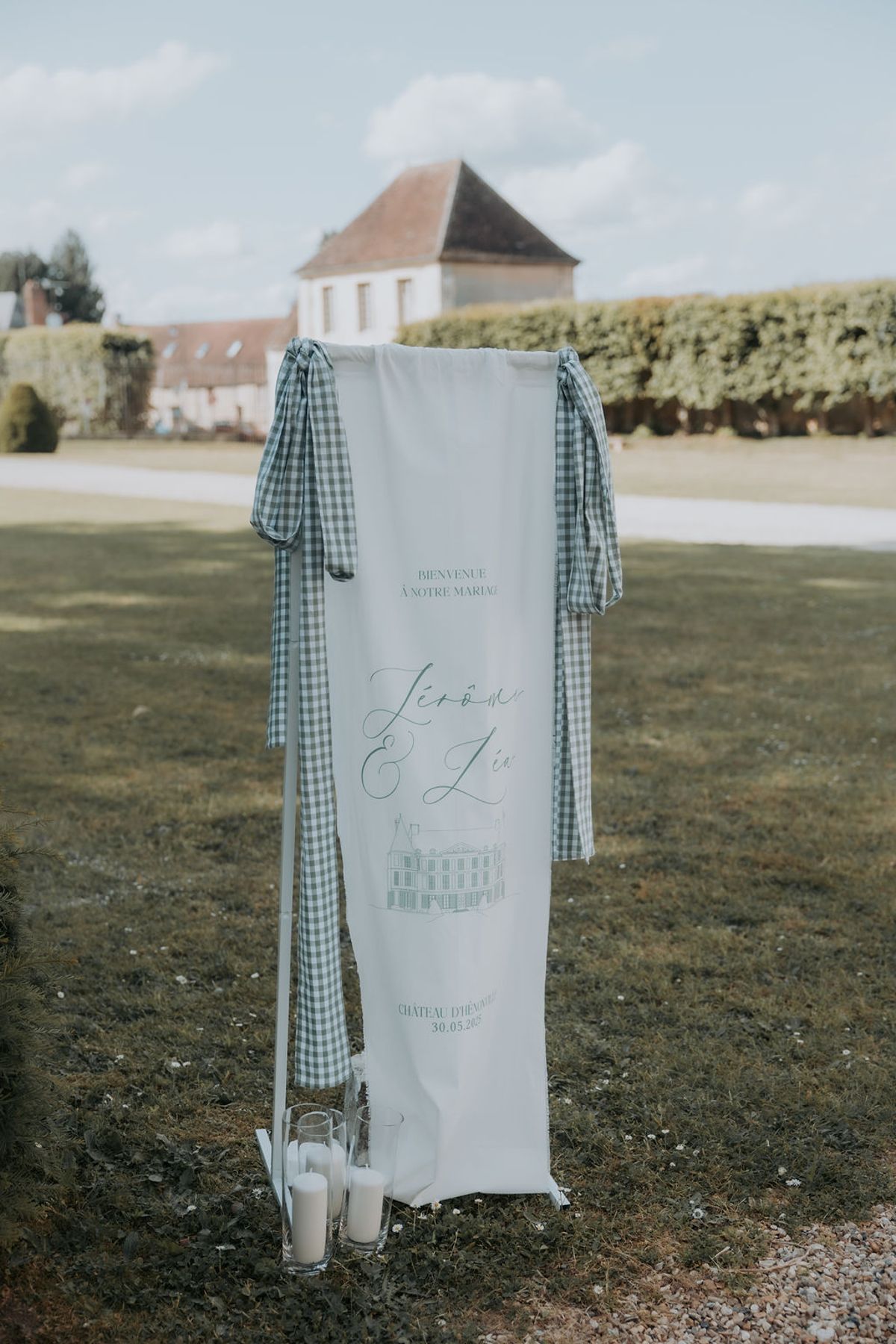 A tall striped fabric banner hung on a stand on the lawn