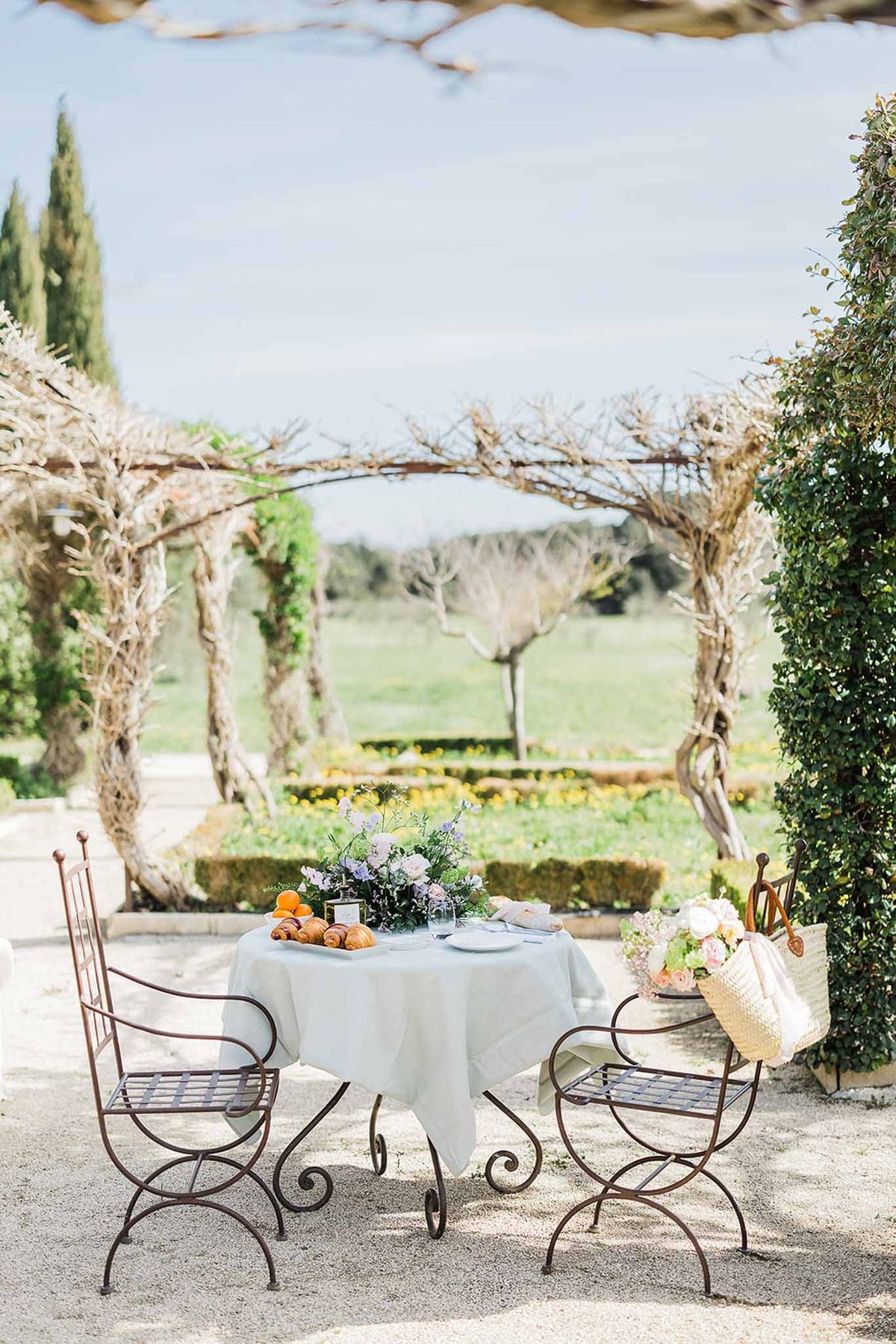 Stone terrace cocktail setup at countryside estate with vineyard views