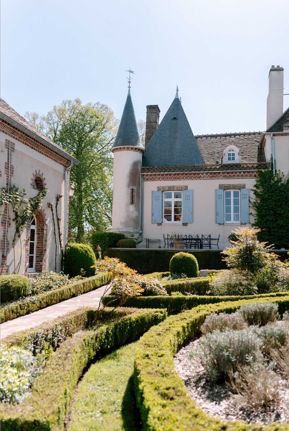 French château venue with round towers and formal parterre gardens for weddings