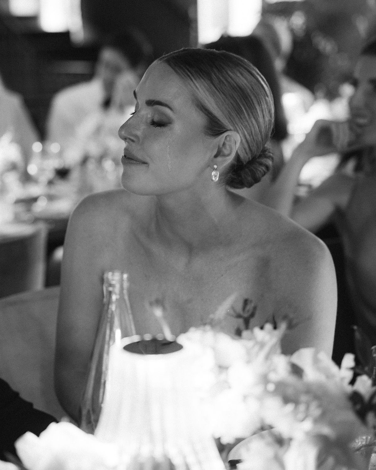 Black and white portrait of the bride with a tear during reception speeches at Restaurant l'Ile, Paris