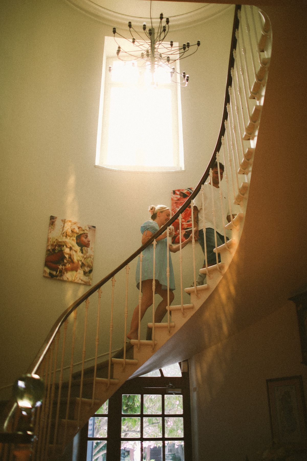 Curved staircase and chandelier inside Chateau du Puits es Pratx, Ginestas