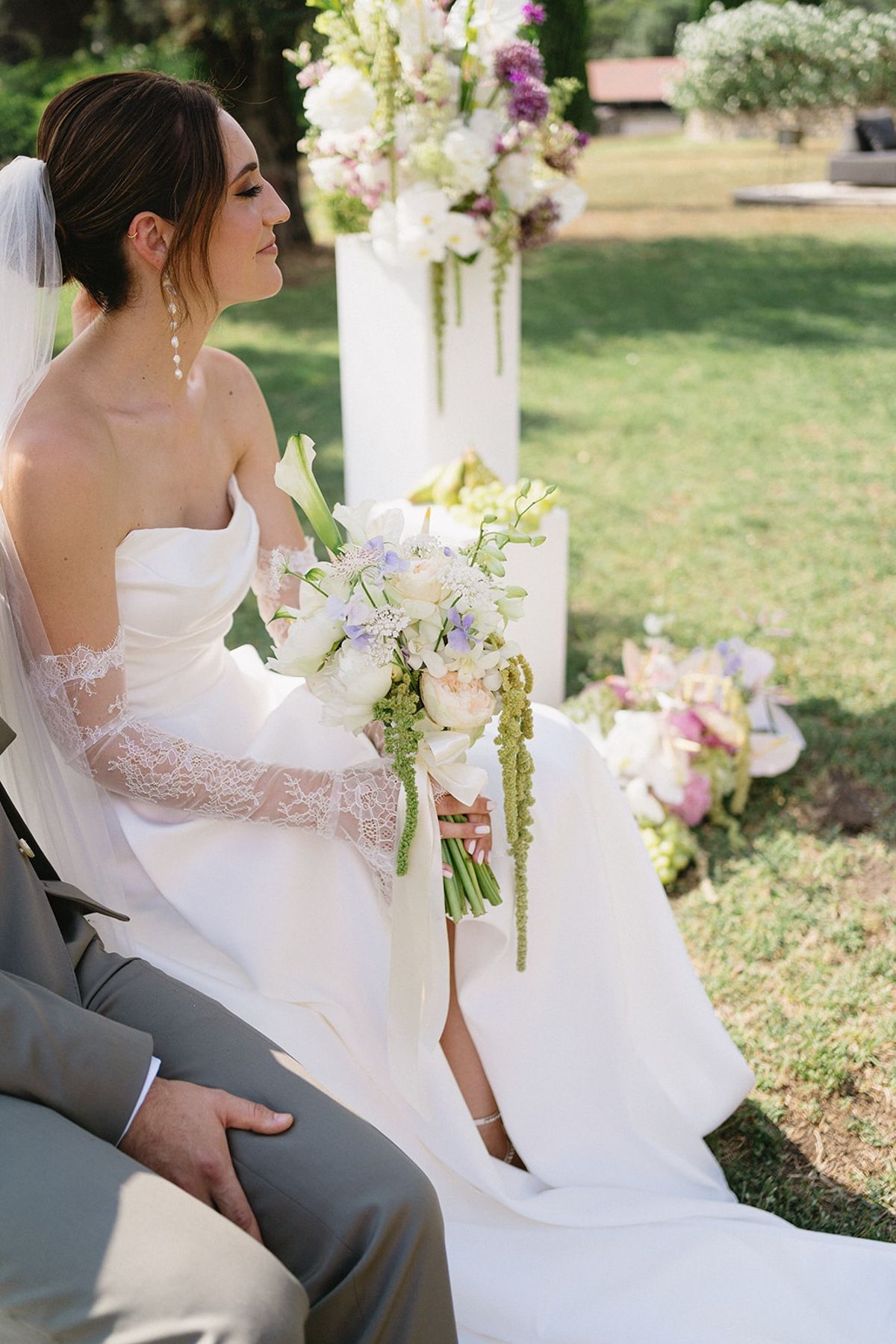 Bride with bouquet beside groom at garden ceremony at Les Domaines de Patras, Provence