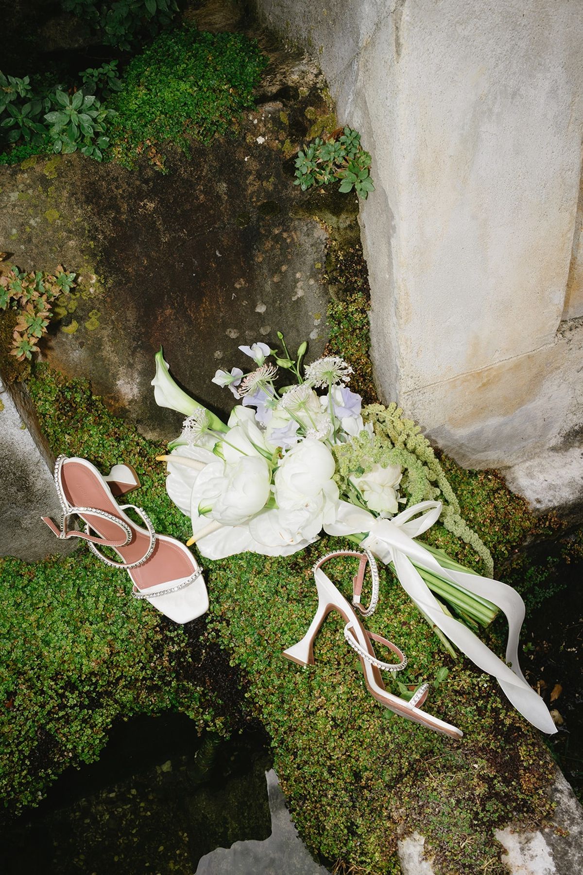 Bridal bouquet and shoes flat lay on stone at Les Domaines de Patras, Provence