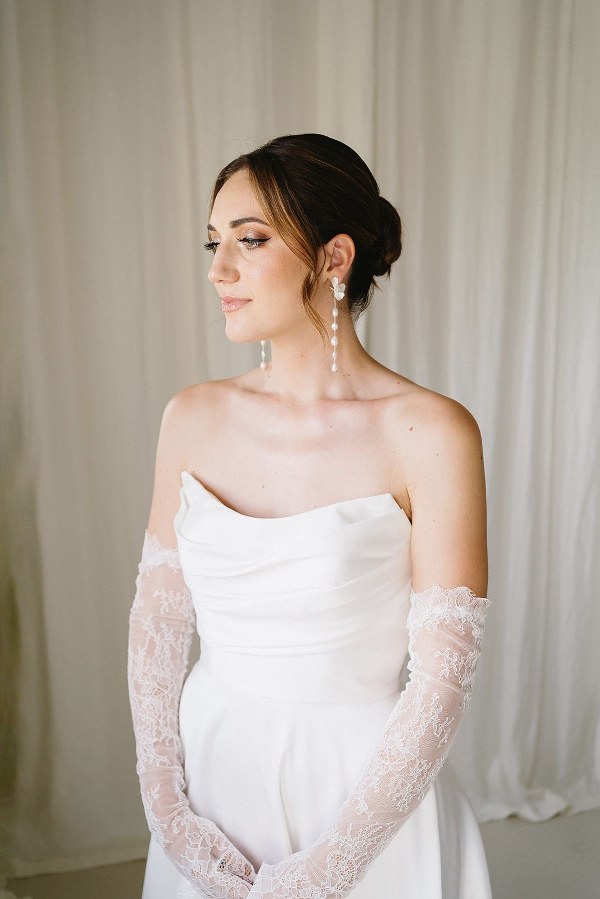 Bride in off-shoulder gown with lace sleeves at Les Domaines de Patras, Provence